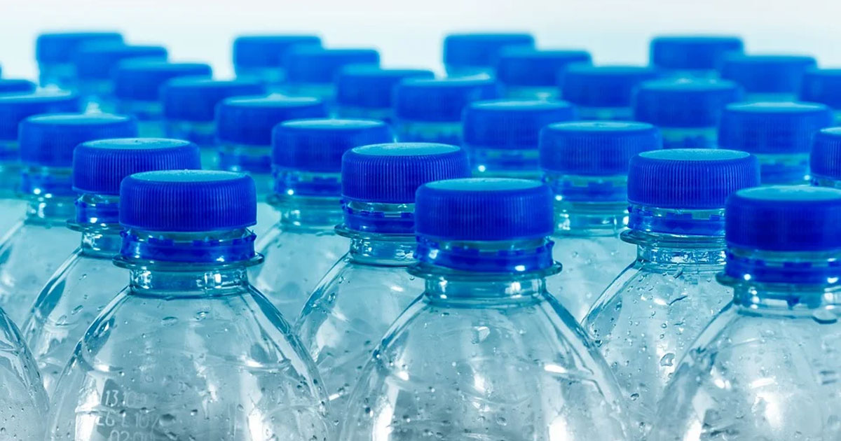 rows of water bottles with blue caps