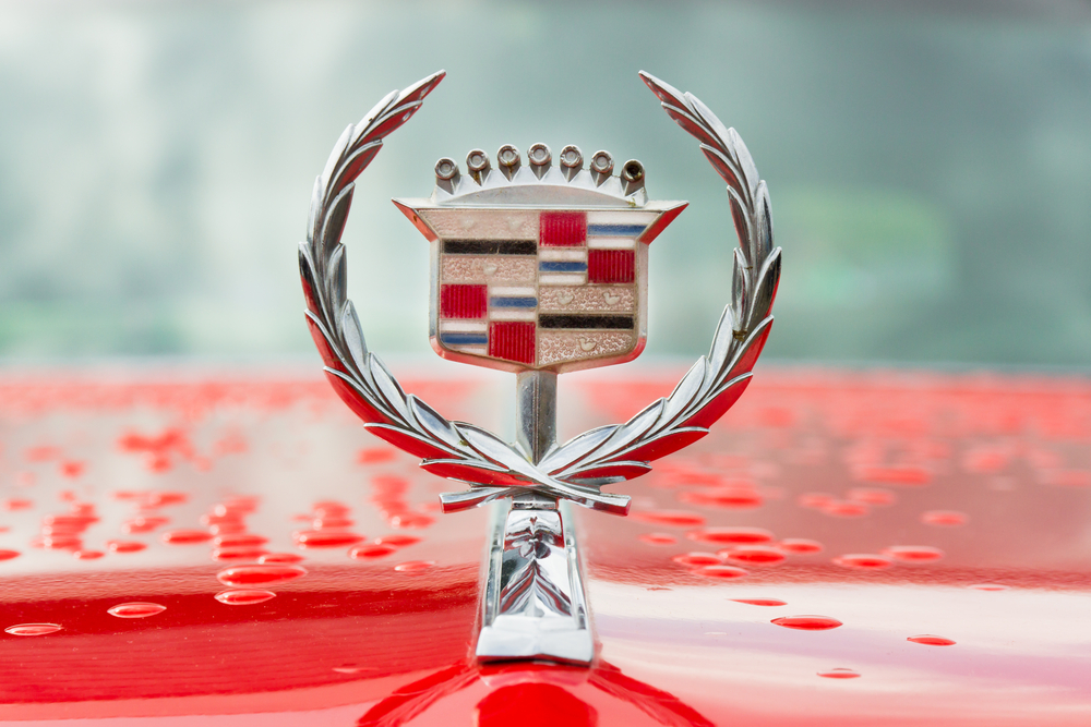 a Cadillac hood emblem on a red hood