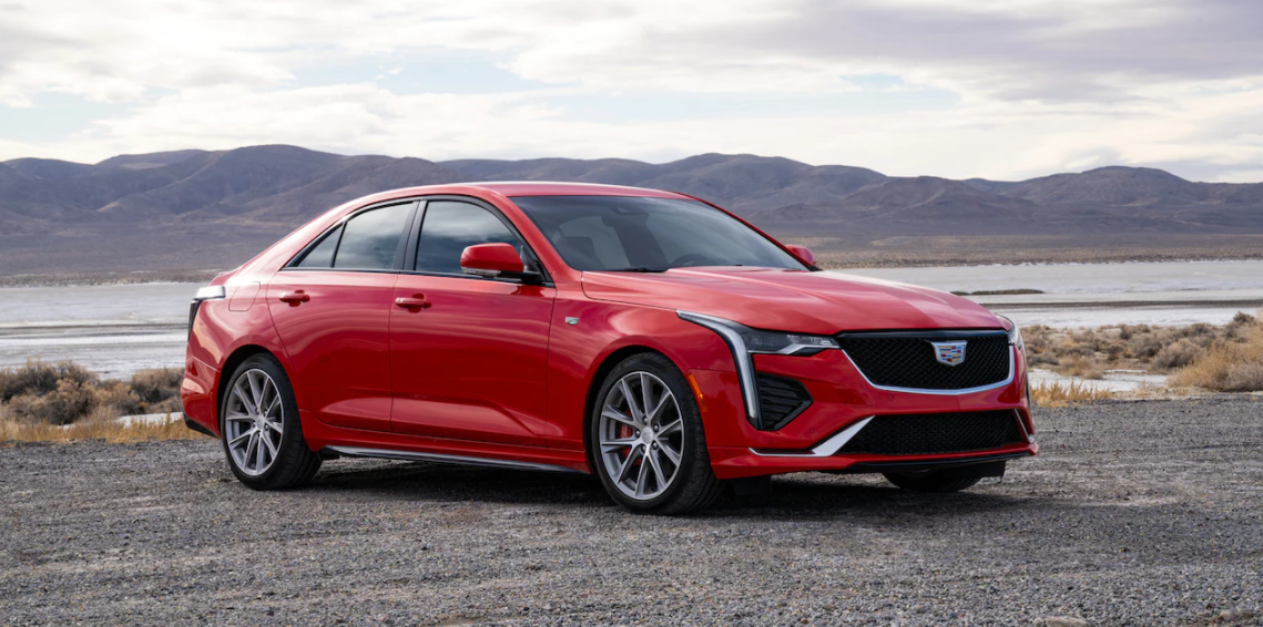 Red 2021 Cadillac CT4 driving down the road