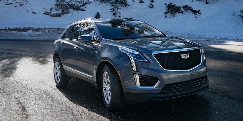 2021 Cadillac XT5 driving down a snowy road