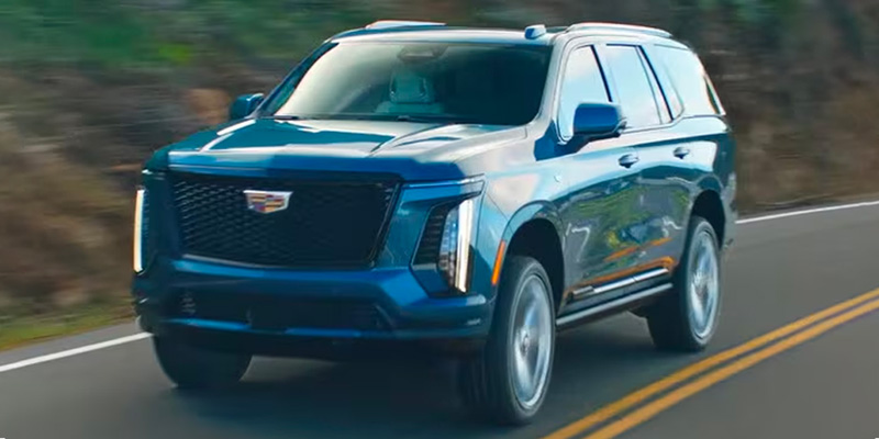 a 2025 Cadillac Escalade driving down a road