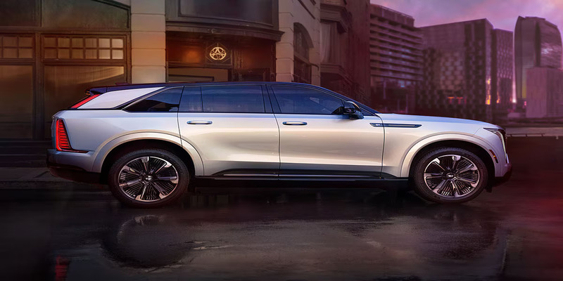 a silver 2025 Cadillac Escalade IQ parked outside a house