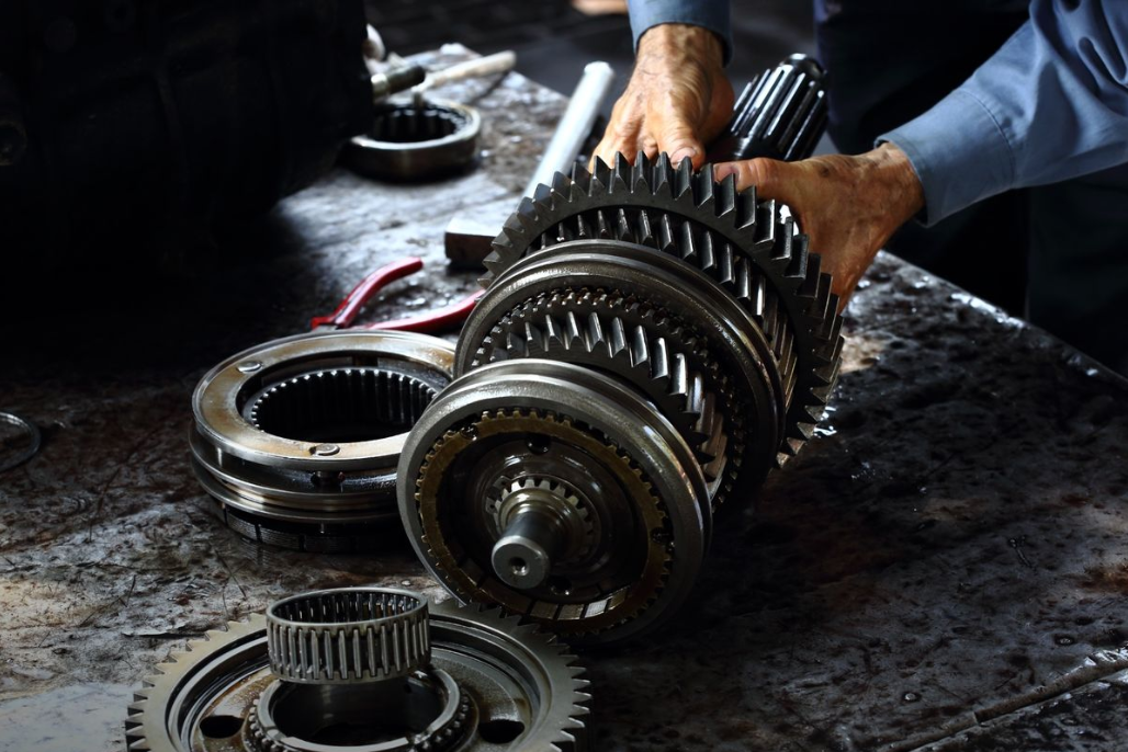 a mechanic working on a car's transmission